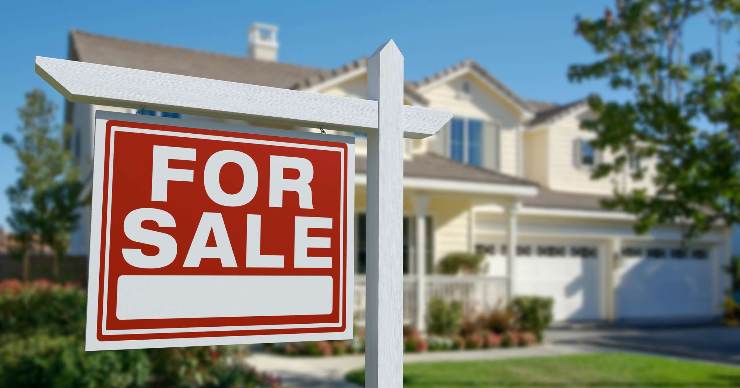 yellow house with a white and red for sale sign in front